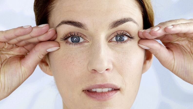 A woman leans her hand near her eyes